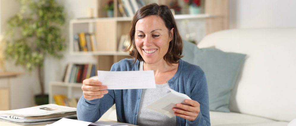 A woman reviewing mail