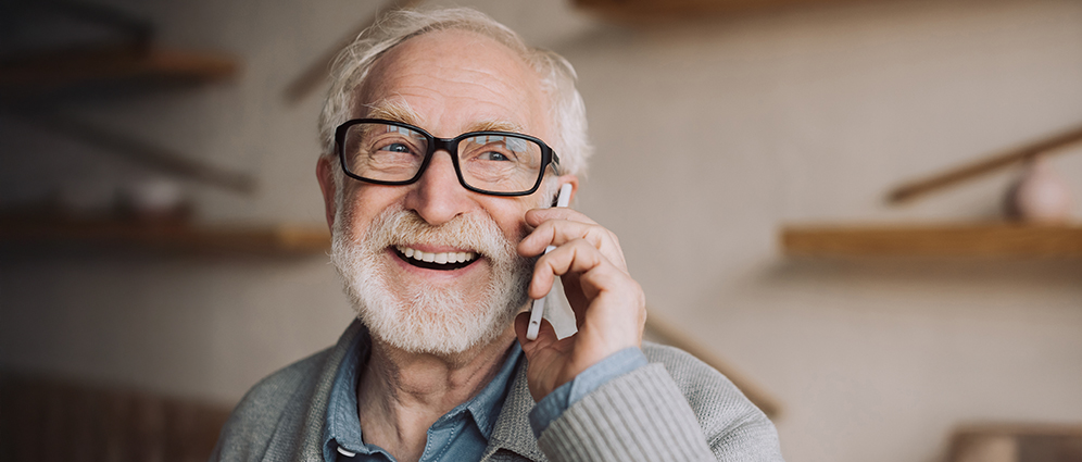 Elderly man talking on a mobile device