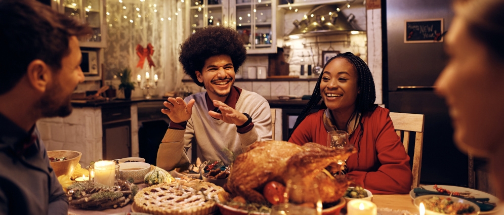 People at a table filled with holiday food