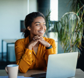 Woman sitting at laptop working.