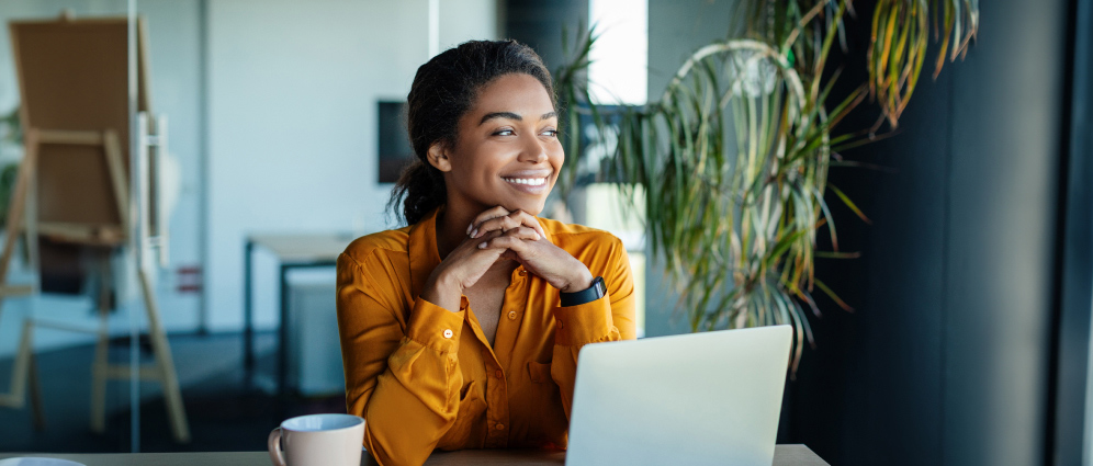 Woman sitting at laptop working.