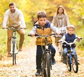 Family riding bikes outside