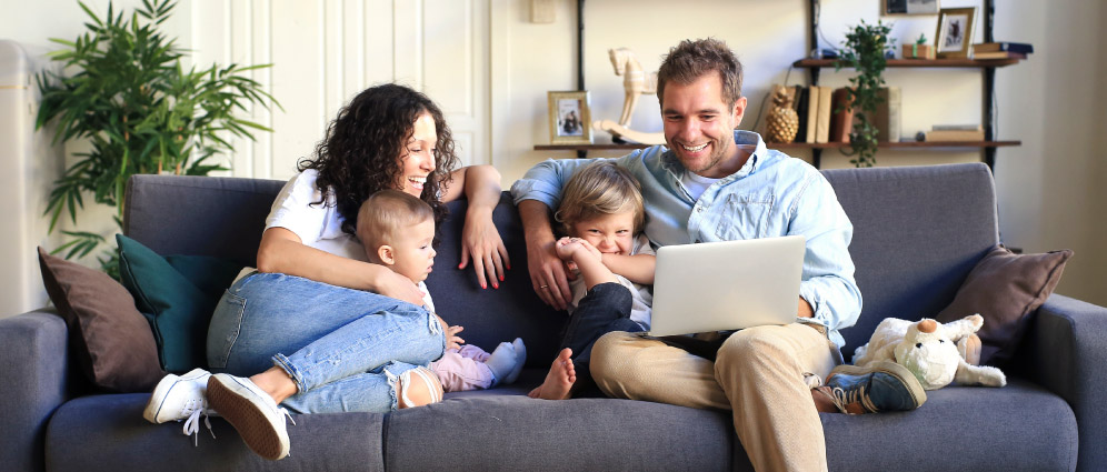 Family of four sitting on couch