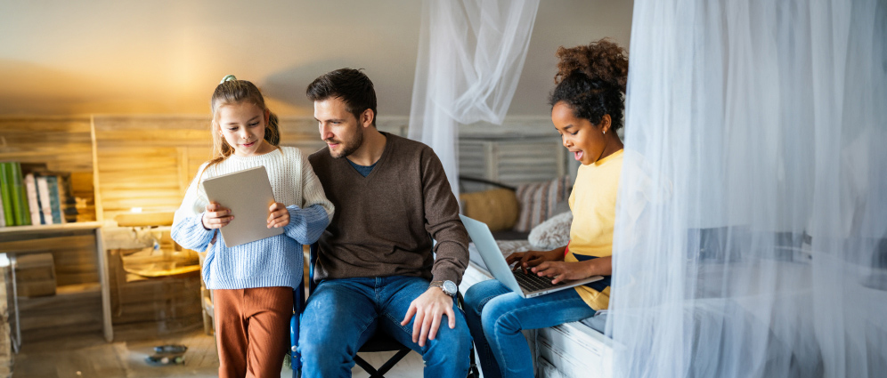 A man and 2 children sitting together learning about health savings accounts.