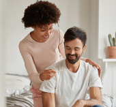 A couple looking at a pregnancy test and smiling.