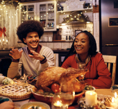 People at a table filled with holiday food