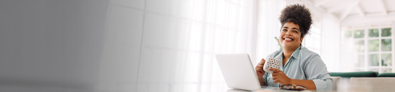 Woman smiling in front of her laptop