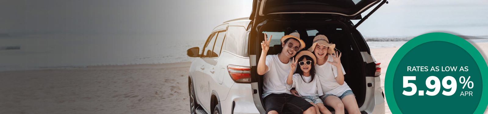 Image of a family having fun at the beach with their vehicle's hatch open.